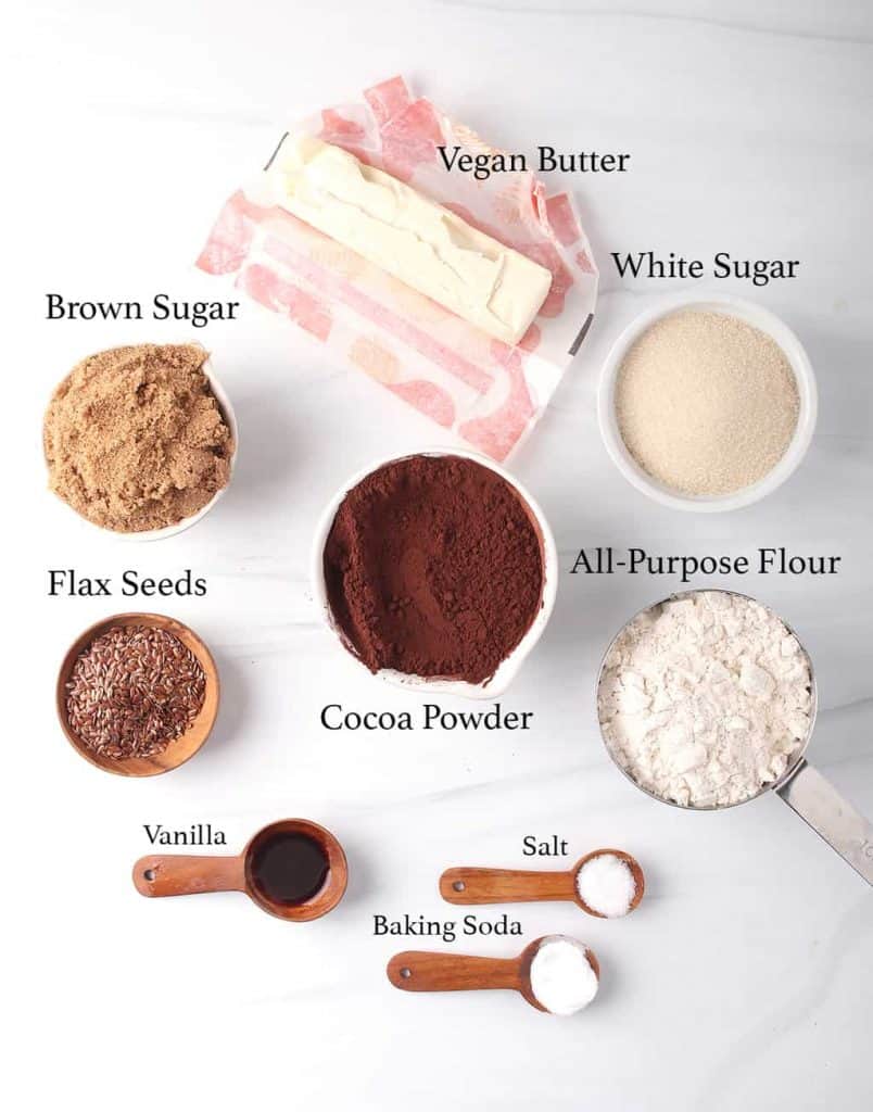 The ingredients for the brownie recipe measured out and placed on a marble background. 