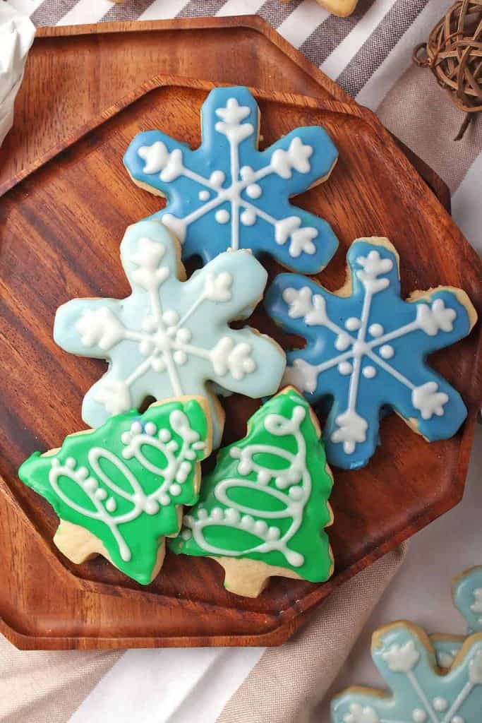 Vegan sugar cookies in shape of Christmas trees and snowflakes