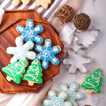 Christmas shaped sugar cookies on a wooden platter