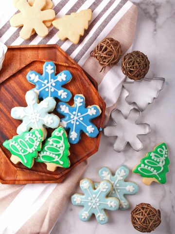 Christmas shaped sugar cookies on a wooden platter