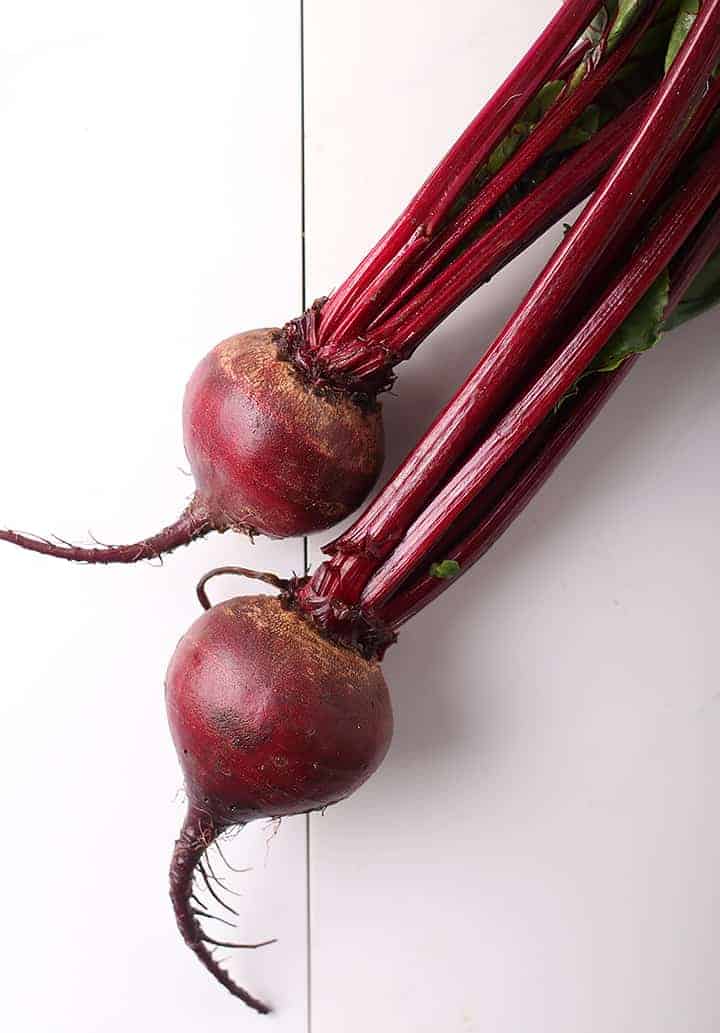 Two beets with stems