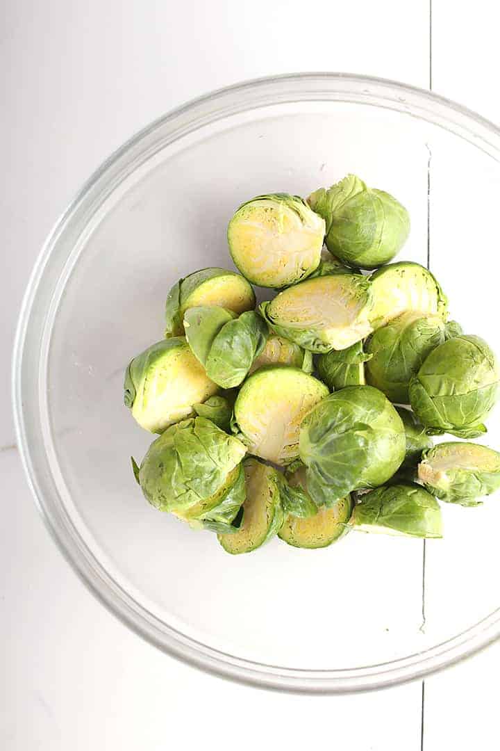 Halved Brussels sprouts in glass bowl