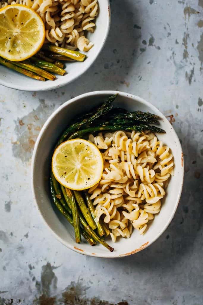 Bowl of lemon pasta and roasted asparagus stalks