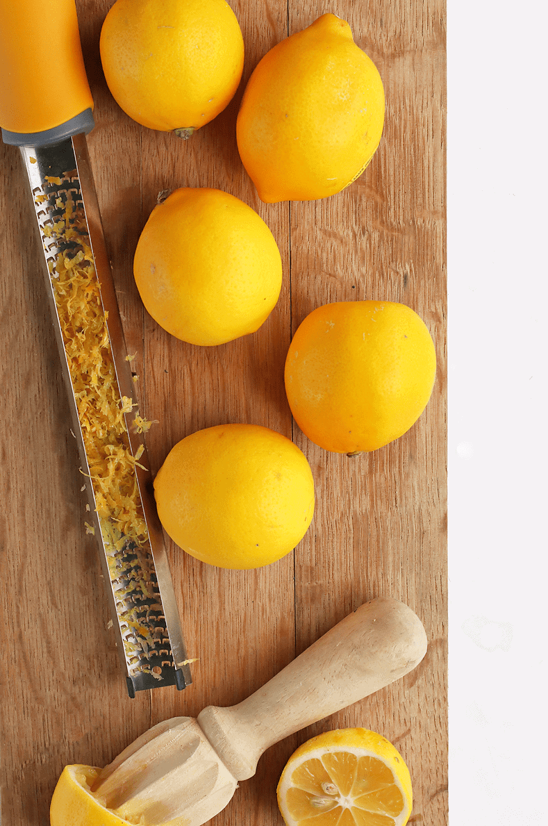 Meyer Lemons on a cutting board with a zester