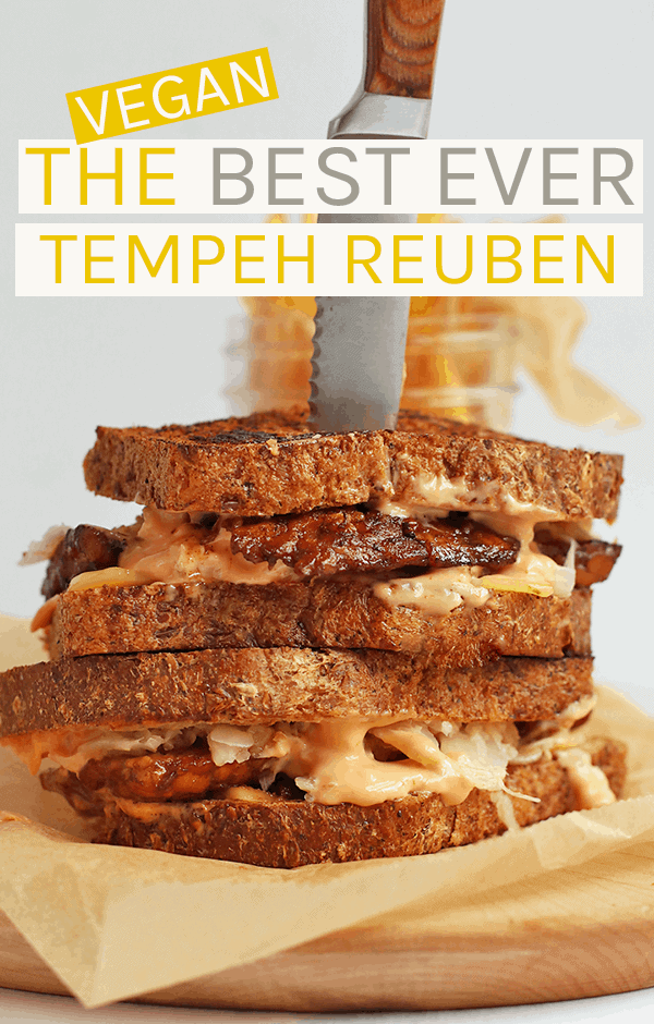 A vegan tempeh reuben made with marinated tempeh, creamy Russian dressing, and sauerkraut sandwiched between two pieces of seedy rye bread #vegan #tempeh #veganrecipes #vegansandwiches
