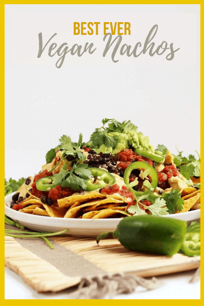 These Homemade Vegan Nachos are made with easy guacamole, vegan queso, and all the fixings for a delicious gluten-free party dish. You won't be able to get enough!